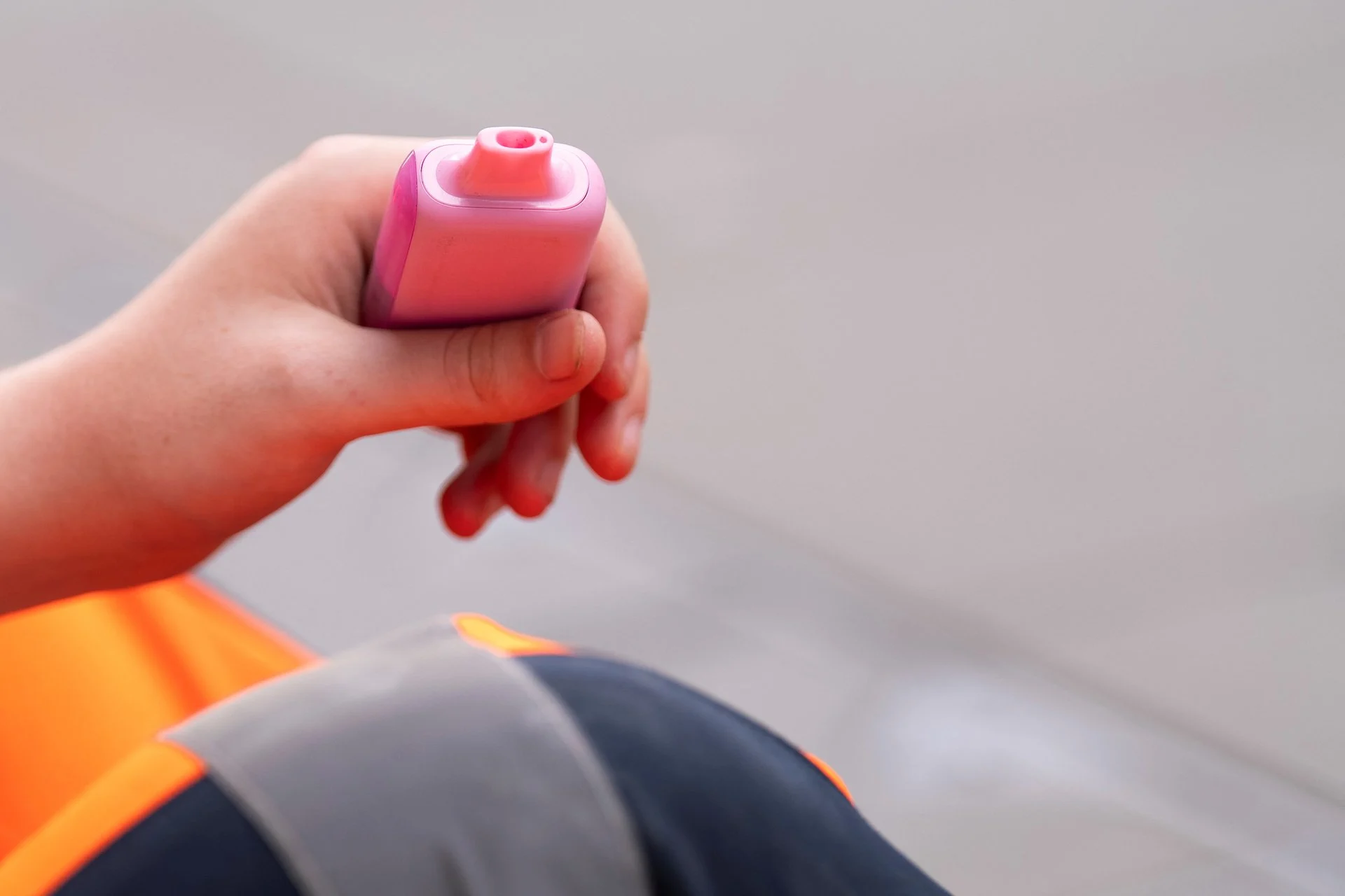 Hand-to-mouth vaping ritual, person holding vape device, physical act of vaping, habitual motion vape use -